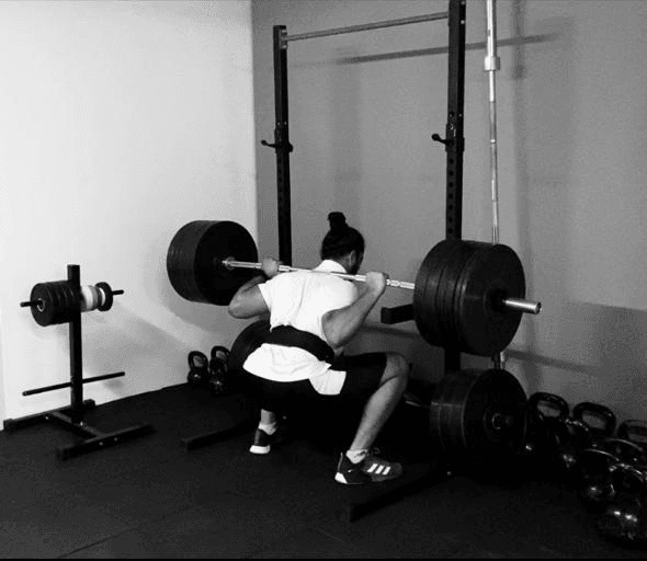 Barbell back squat in home gym